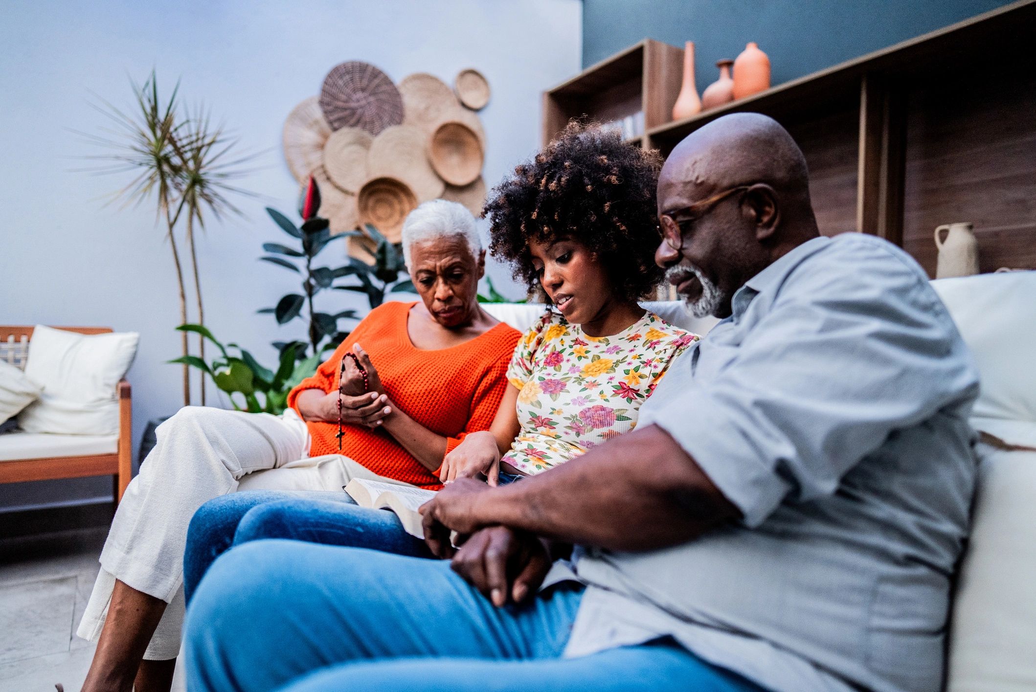 Family praying and reading the Bible together